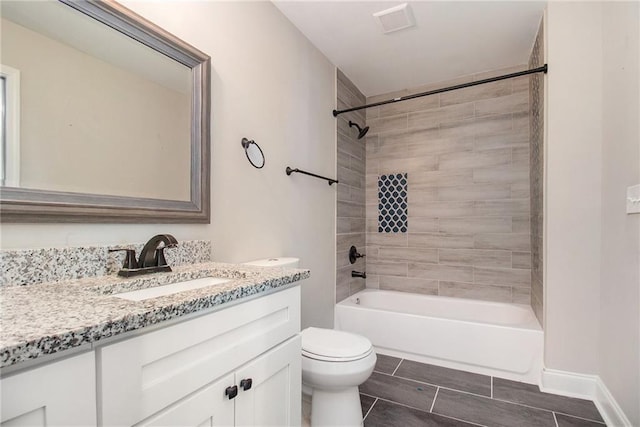 full bathroom featuring tiled shower / bath combo, vanity, and toilet