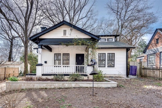 bungalow featuring fence and a porch