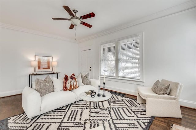 living area with ceiling fan, ornamental molding, wood finished floors, and baseboards