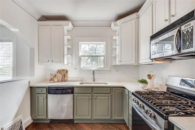 kitchen featuring dark wood-type flooring, a sink, visible vents, appliances with stainless steel finishes, and open shelves