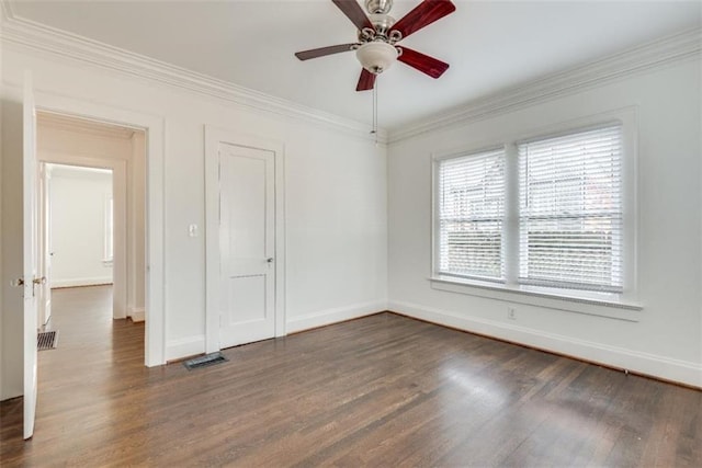 spare room with a ceiling fan, baseboards, dark wood-style flooring, and crown molding