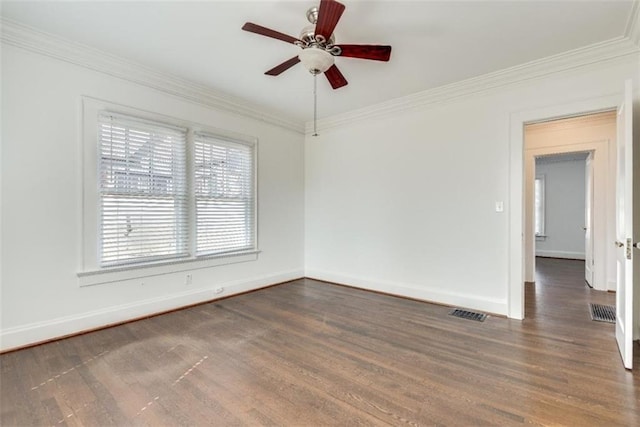 unfurnished room with ornamental molding, baseboards, and wood finished floors