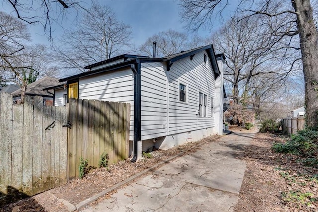 view of property exterior featuring crawl space and fence