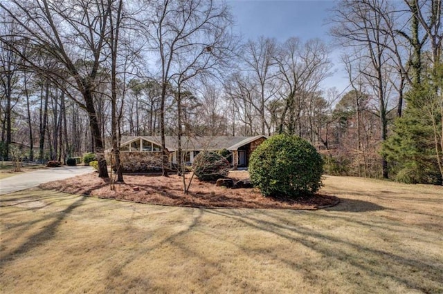 view of front of house with driveway and a front lawn