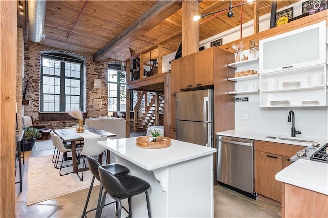 kitchen featuring wooden ceiling, brick wall, appliances with stainless steel finishes, open shelves, and beam ceiling