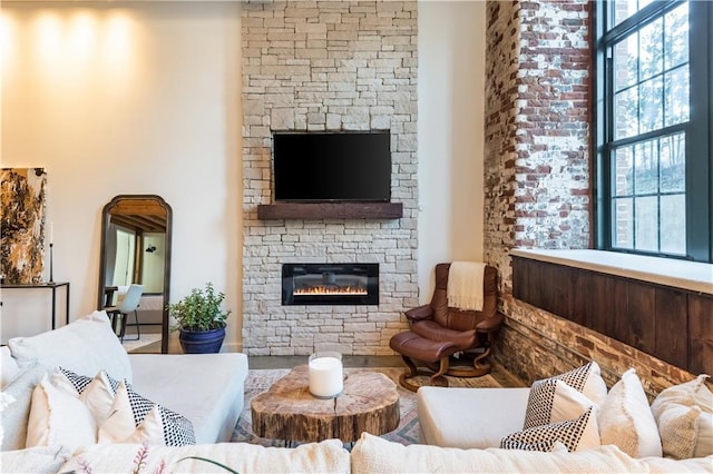 living area featuring a stone fireplace