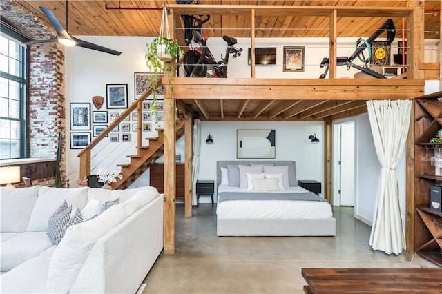 bedroom featuring finished concrete flooring and wood ceiling