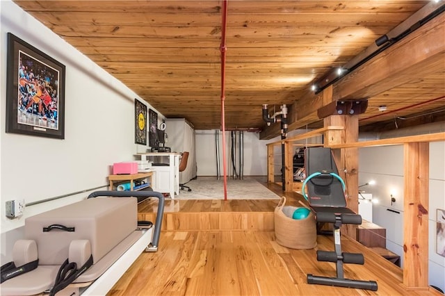 exercise room featuring wooden ceiling and wood finished floors