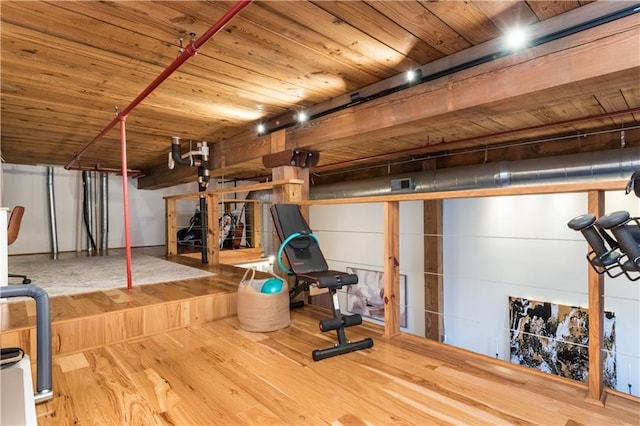 workout area featuring wood ceiling and wood finished floors