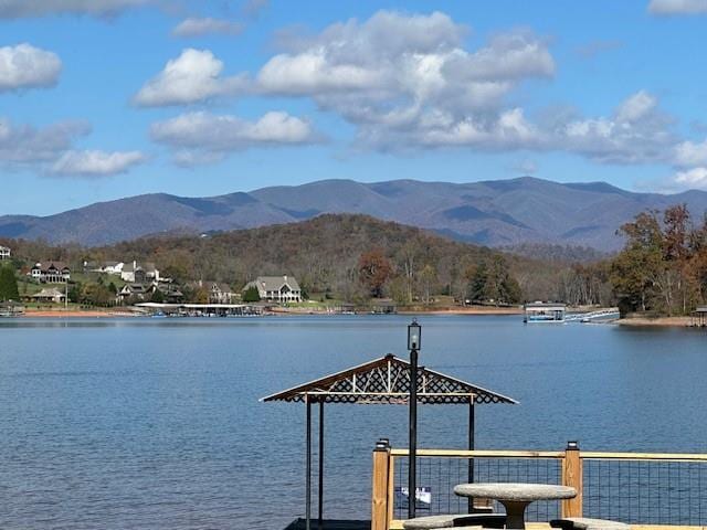 view of dock with a water and mountain view