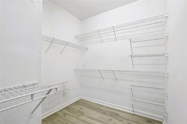 7712 Soaring Eagle Dr, Flowery Branch, GA 30542 - spacious closet featuring wood finished floors
