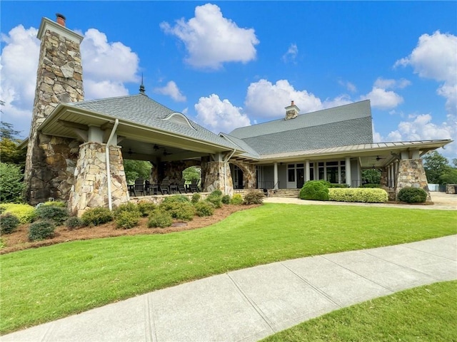 7712 Soaring Eagle Dr, Flowery Branch, GA 30542 - view of front of home with ceiling fan, stone siding, and a chimney