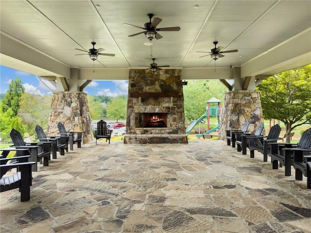 7712 Soaring Eagle Dr, Flowery Branch, GA 30542 - view of patio with a ceiling fan and an outdoor stone fireplace
