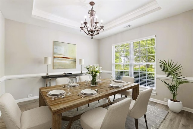 7712 Soaring Eagle Dr, Flowery Branch, GA 30542 - dining space featuring light wood-type flooring, a raised ceiling, baseboards, and a chandelier
