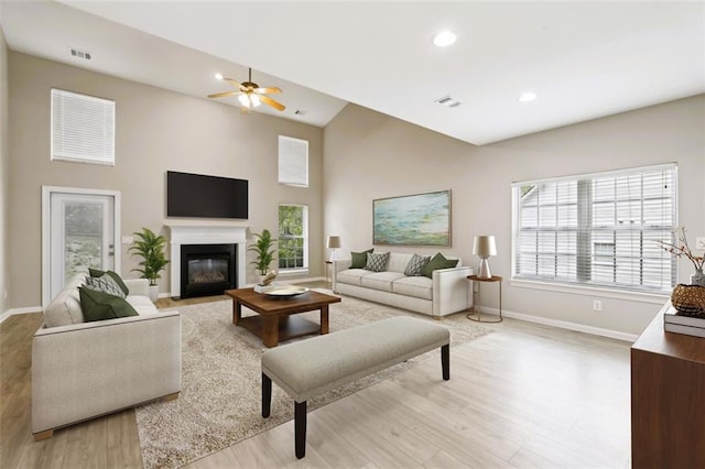 7712 Soaring Eagle Dr, Flowery Branch, GA 30542 - living room with visible vents, a fireplace with flush hearth, light wood-type flooring, baseboards, and recessed lighting