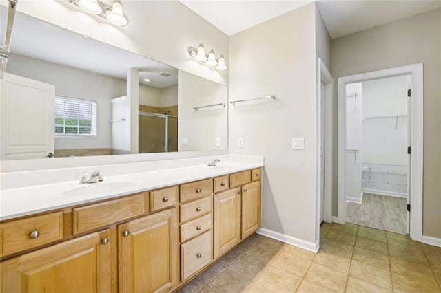 7712 Soaring Eagle Dr, Flowery Branch, GA 30542 - full bath with double vanity, tile patterned flooring, a stall shower, a sink, and baseboards