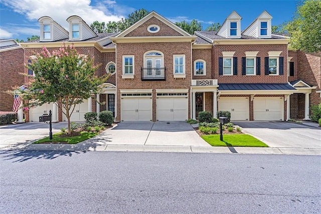 view of front of home featuring a garage, driveway, and brick siding