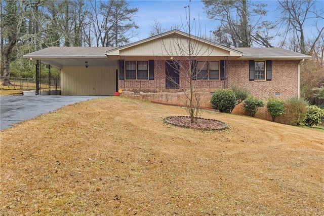 ranch-style house with a carport and a front lawn