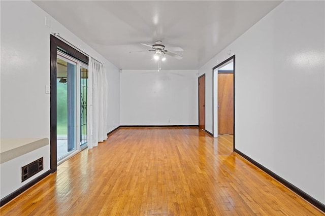 empty room with ceiling fan and light wood-type flooring