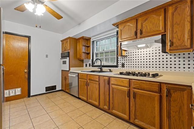 kitchen featuring sink, tasteful backsplash, gas cooktop, dishwasher, and oven