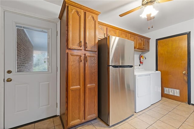 clothes washing area with ceiling fan, separate washer and dryer, and light tile patterned floors