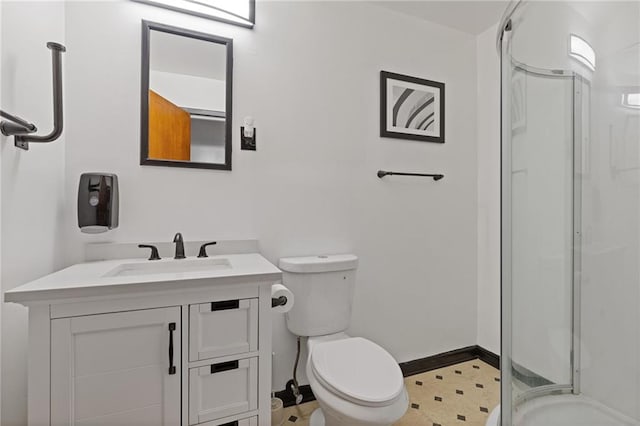 bathroom with a shower with door, vanity, and toilet