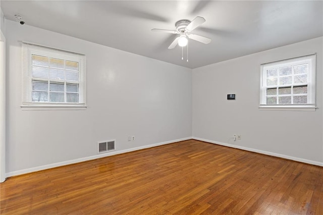 unfurnished room with hardwood / wood-style flooring and ceiling fan