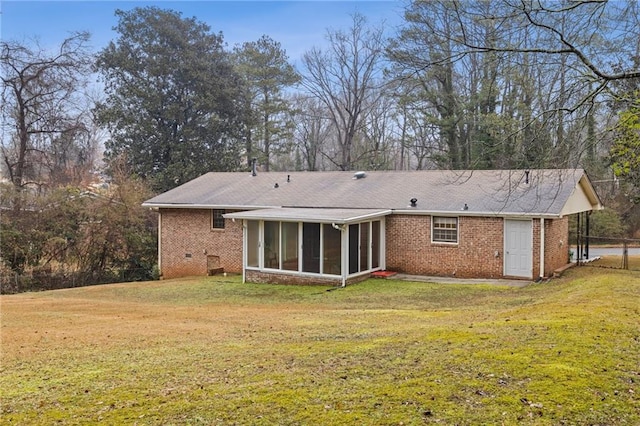 back of house with a yard and a sunroom