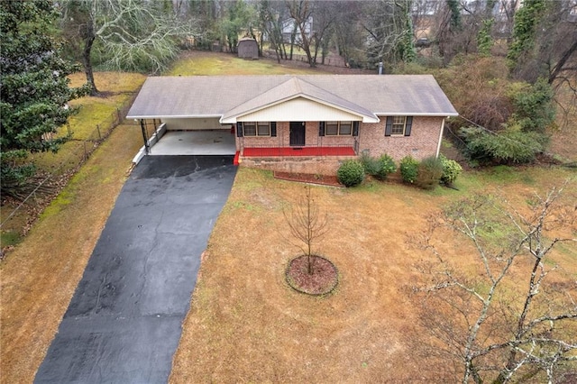 ranch-style home with a front yard and a carport