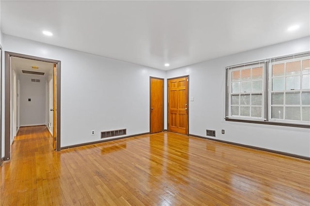 spare room featuring light hardwood / wood-style floors