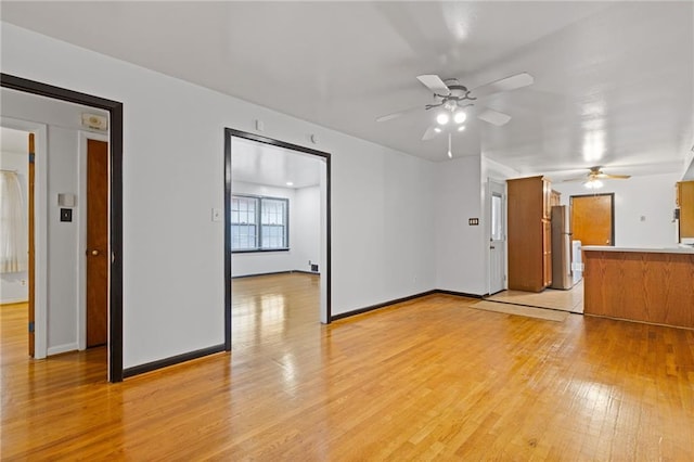 unfurnished living room with light hardwood / wood-style floors and ceiling fan