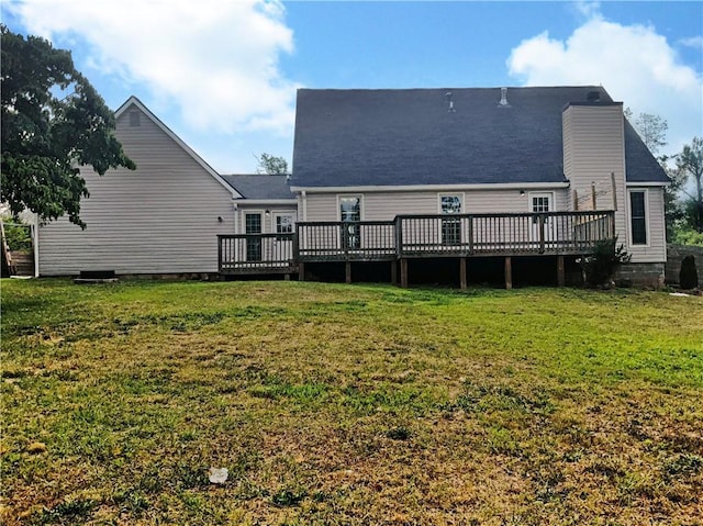 rear view of house featuring a yard and a wooden deck