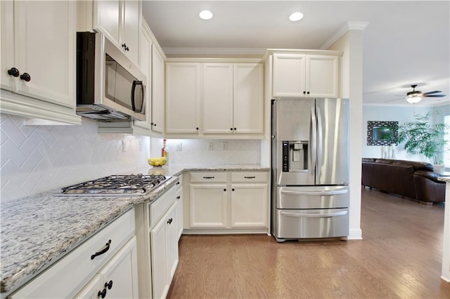 1803 Stone Bridge Way, Marietta, GA 30064 - kitchen with white cabinets, a ceiling fan, light wood-type flooring, and stainless steel appliances