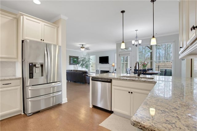 1803 Stone Bridge Way, Marietta, GA 30064 - kitchen featuring light wood-style flooring, a fireplace, a sink, ornamental molding, and stainless steel appliances
