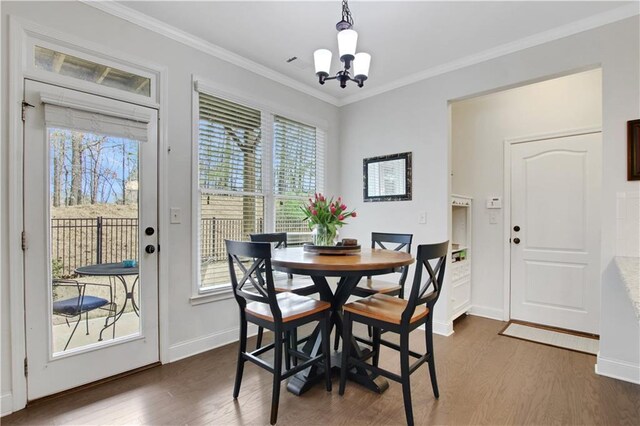 1803 Stone Bridge Way, Marietta, GA 30064 - dining space featuring baseboards, dark wood-type flooring, an inviting chandelier, and ornamental molding