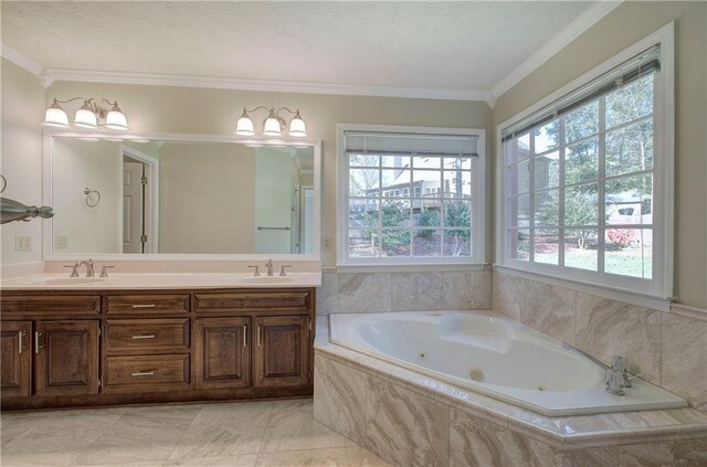 bathroom with tiled tub, crown molding, vanity, and a textured ceiling