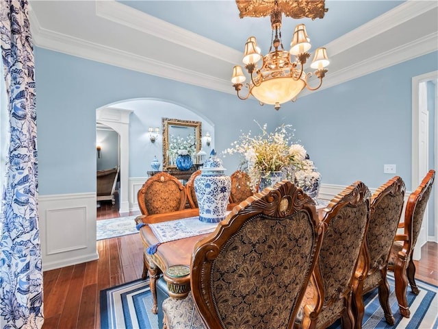 7060 Summit Rdg, Chase, Cumming, GA 30041 - dining room featuring a chandelier, wood-type flooring, arched walkways, a raised ceiling, and a wainscoted wall