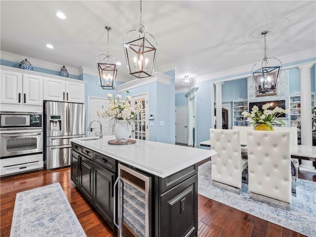 7060 Summit Rdg, Chase, Cumming, GA 30041 - kitchen with stainless steel appliances, a chandelier, beverage cooler, ornamental molding, and white cabinets