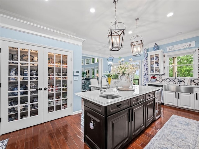 7060 Summit Rdg, Chase, Cumming, GA 30041 - kitchen featuring a sink, ornamental molding, light countertops, beverage cooler, and a chandelier