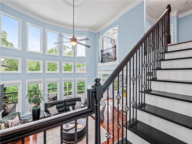 7060 Summit Rdg, Chase, Cumming, GA 30041 - stairway featuring wood finished floors, ceiling fan, ornamental molding, and a towering ceiling