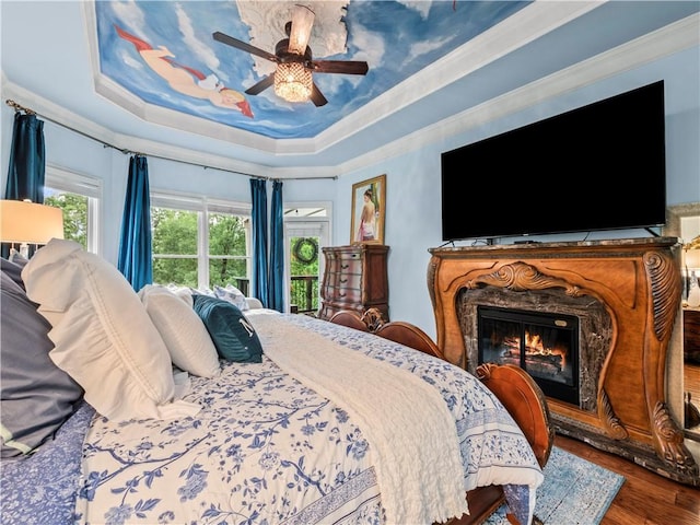 7060 Summit Rdg, Chase, Cumming, GA 30041 - bedroom featuring wood finished floors, a high end fireplace, a raised ceiling, a ceiling fan, and ornamental molding
