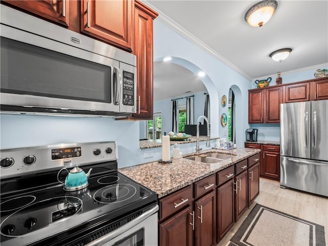 7060 Summit Rdg, Chase, Cumming, GA 30041 - kitchen featuring appliances with stainless steel finishes, a sink, arched walkways, light stone countertops, and crown molding