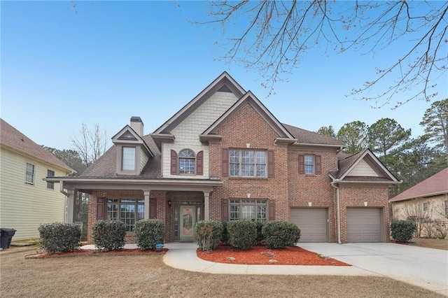 2143 Great Shoals Cir, Lawrenceville, GA 30045 - view of front of property with a porch, brick siding, concrete driveway, a chimney, and a front yard