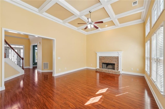 2143 Great Shoals Cir, Lawrenceville, GA 30045 - unfurnished living room with stairs, a high ceiling, a brick fireplace, and visible vents