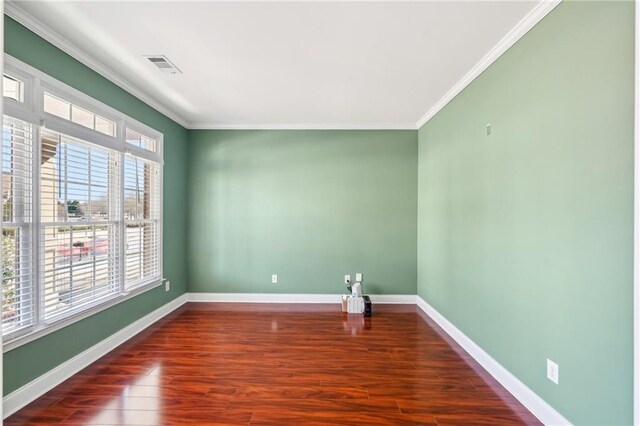 2143 Great Shoals Cir, Lawrenceville, GA 30045 - empty room with dark wood-style flooring, visible vents, crown molding, and baseboards