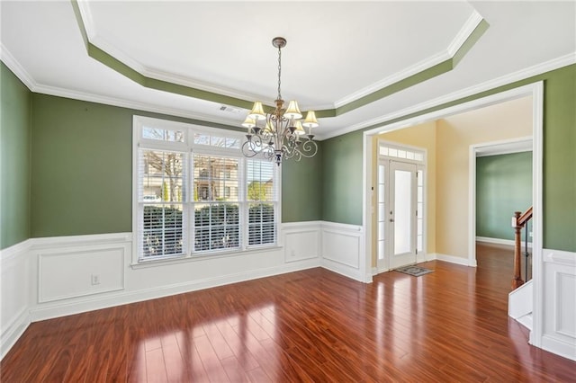 2143 Great Shoals Cir, Lawrenceville, GA 30045 - unfurnished dining area with dark wood-type flooring, a raised ceiling, a notable chandelier, and wainscoting
