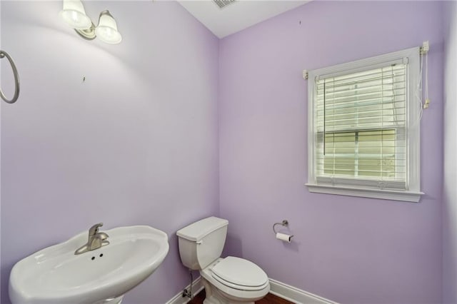 2143 Great Shoals Cir, Lawrenceville, GA 30045 - half bath with baseboards, a sink, visible vents, and toilet