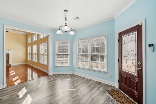 2143 Great Shoals Cir, Lawrenceville, GA 30045 - unfurnished dining area featuring dark wood-style floors, baseboards, visible vents, and crown molding