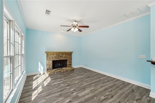 2143 Great Shoals Cir, Lawrenceville, GA 30045 - unfurnished living room with baseboards, a stone fireplace, visible vents, and crown molding