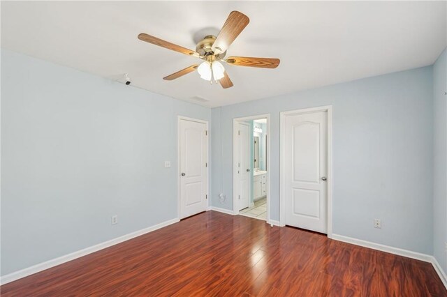2143 Great Shoals Cir, Lawrenceville, GA 30045 - unfurnished bedroom with a ceiling fan, connected bathroom, baseboards, and wood finished floors